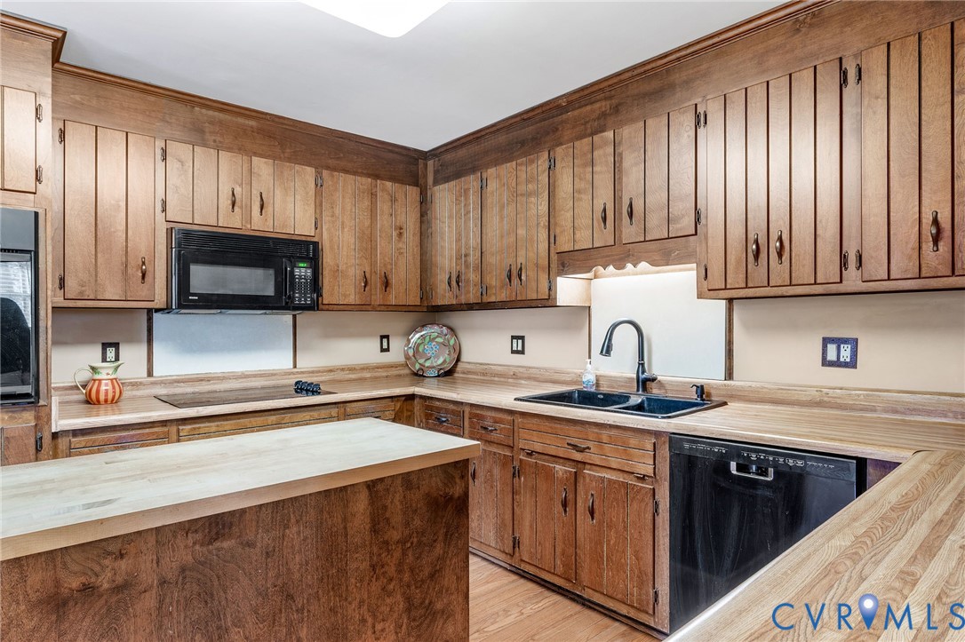 2901 Tipton Street Colonial Heights, VA 23834 - Photo 12 of 29 a kitchen with stainless steel appliances granite countertop a sink stove and microwave with wooden cabinets