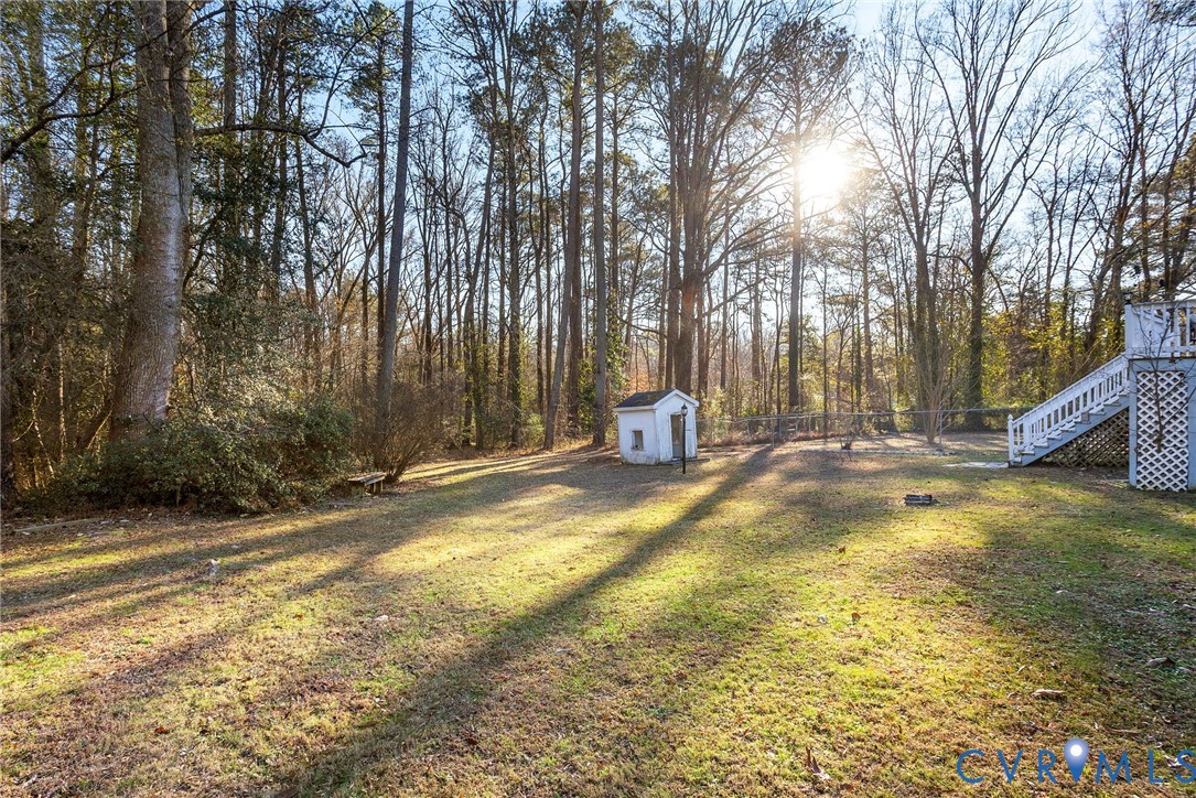 2901 Tipton Street Colonial Heights, VA 23834 - Photo 25 of 29 Fenced backyard with a storage unit, stairs, and a
