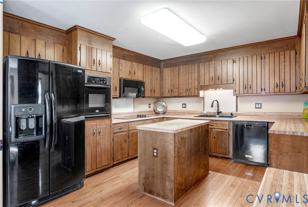 2901 Tipton Street Colonial Heights, VA 23834 - Photo 10 of 29 a kitchen with stainless steel appliances granite countertop a refrigerator a sink dishwasher a stove top oven a refrigerator and cabinets with wooden floor
