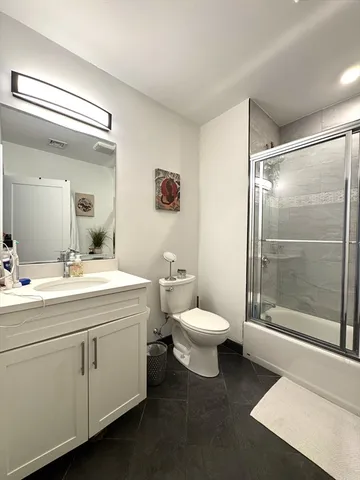 a bathroom with a toilet sink and shower