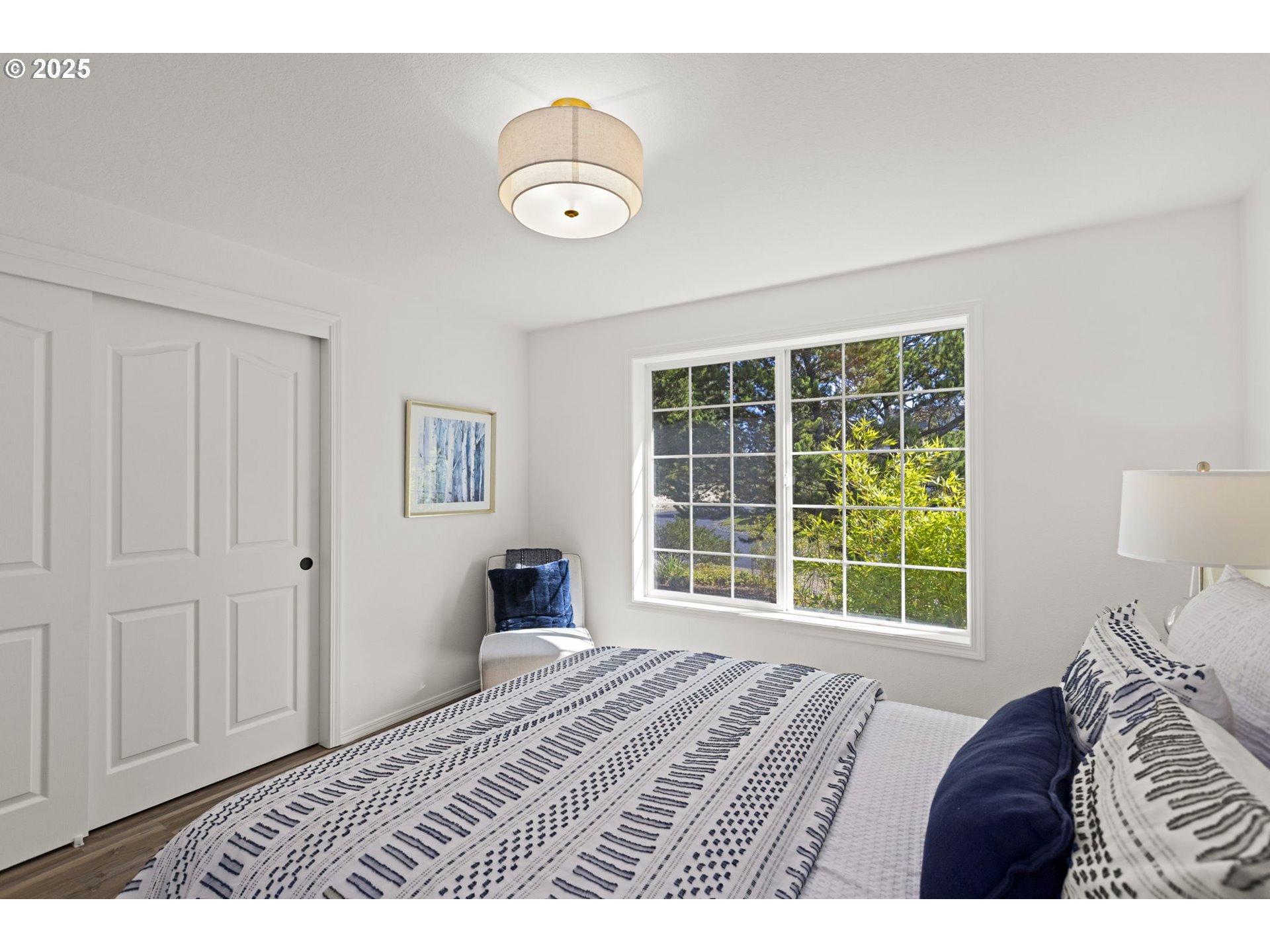 9980 Pine Ridge Drive Nehalem, OR 97131 - Photo 18 of 27 a bedroom with a bed and a window