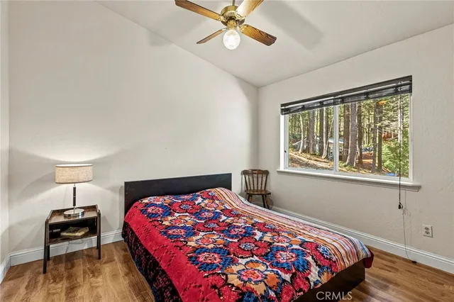 a bedroom with a bed and a lamp on a dresser