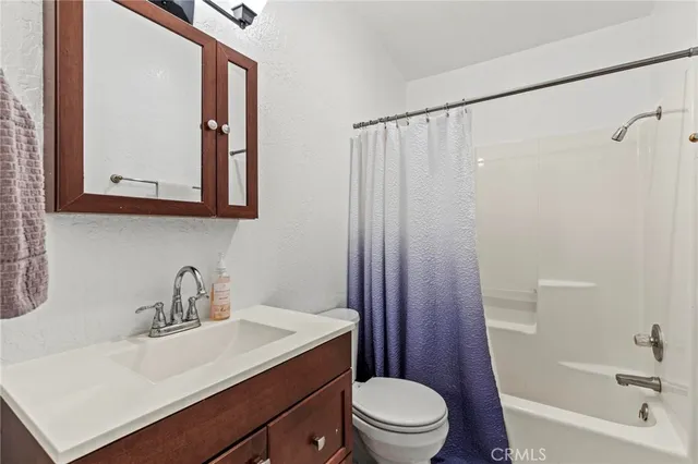 a en suite bathroom with a sink vanity and mirror