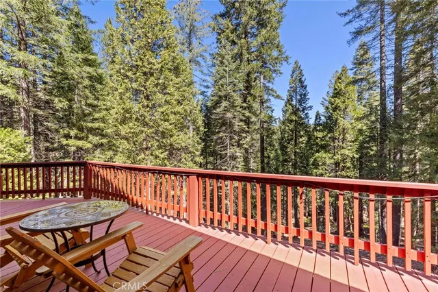 a view of balcony with wooden floor and outdoor seating