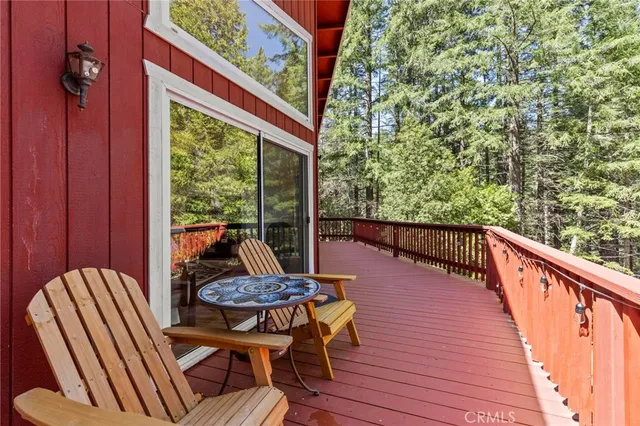 a view of balcony with wooden floor and outdoor seating
