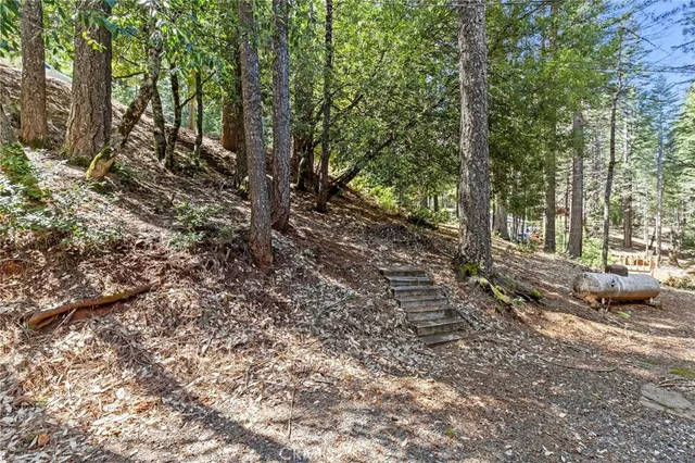 a backyard of a house with barbeque oven fire pit table and chairs