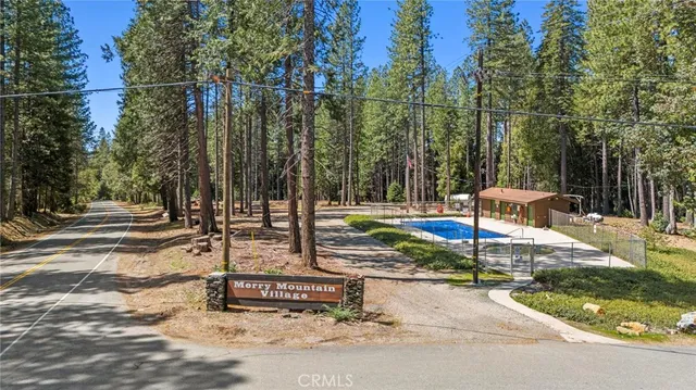 a view of a house with swimming pool and sitting area