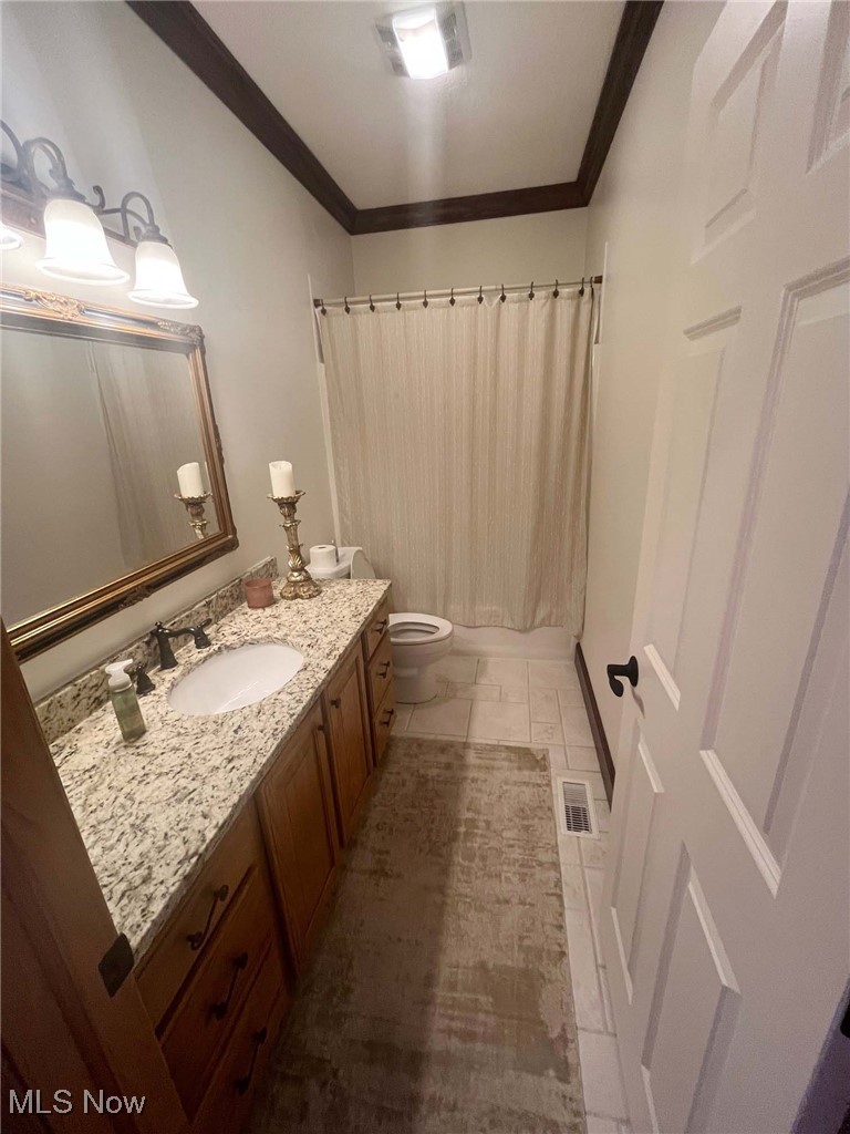 2159 Alliance Road Deerfield, OH 44411 - Photo 23 of 33 Bathroom featuring crown molding, vanity, visible vents, and toilet