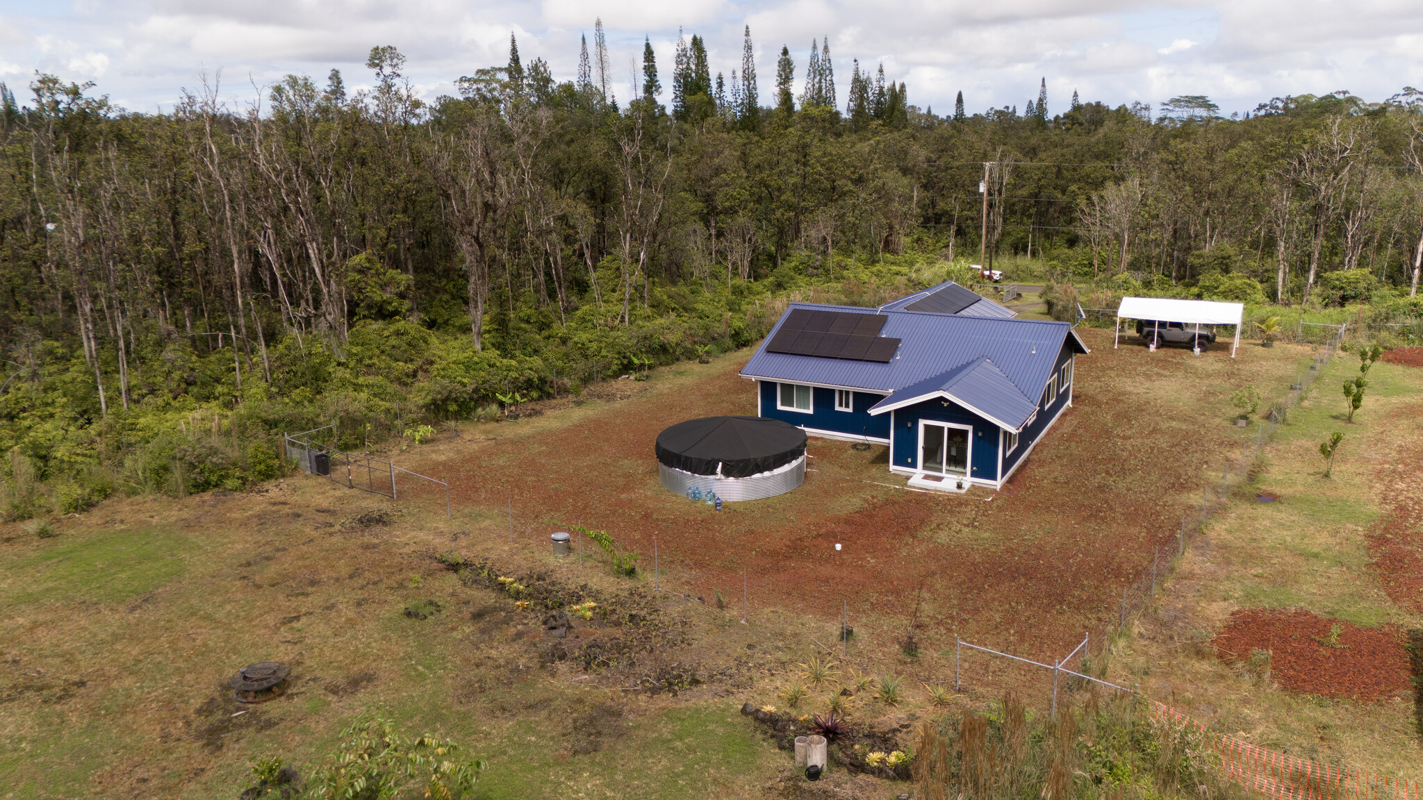 11-2789 Hibiscus Street Mountain View, HI 96771 - Photo 27 of 30 an aerial view of a house with garden space and trees all around