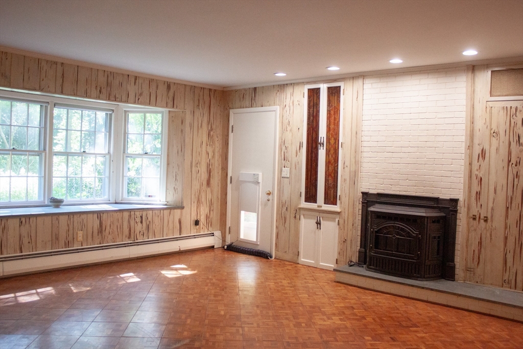 13 Montclair Drive Worcester, MA 01609 - Photo 12 of 38 a view of an empty room with a fireplace and a window