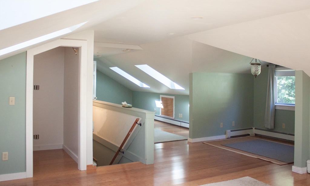 13 Montclair Drive Worcester, MA 01609 - Photo 23 of 38 a view of a livingroom with wooden floor and stairs