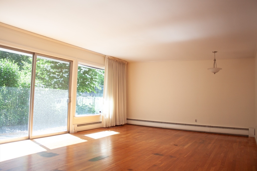 13 Montclair Drive Worcester, MA 01609 - Photo 8 of 38 an empty room with wooden floor and windows