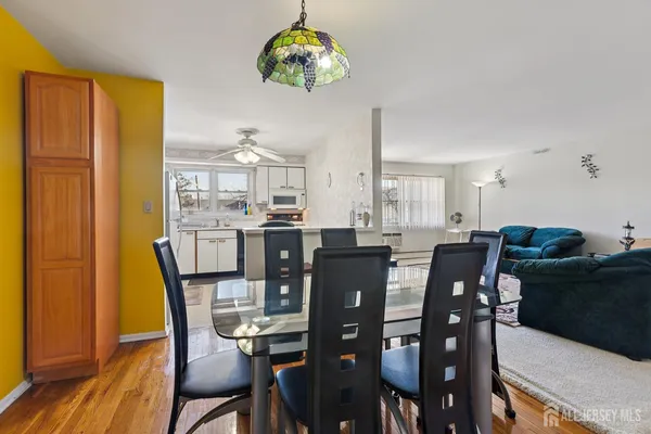 a view of a dining room with furniture window and wooden floor