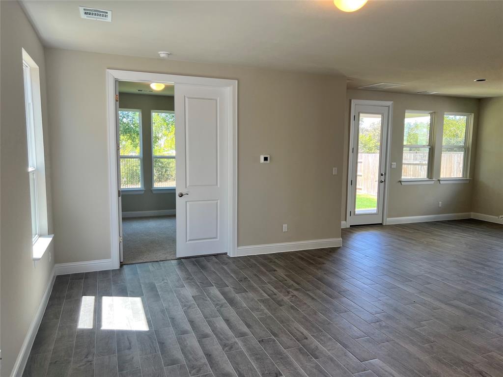 128 Free Stone Drive Georgetown, TX 78628 - Photo 4 of 29 Spacious interior with wood-finish flooring, neutral paint palette, and white baseboards