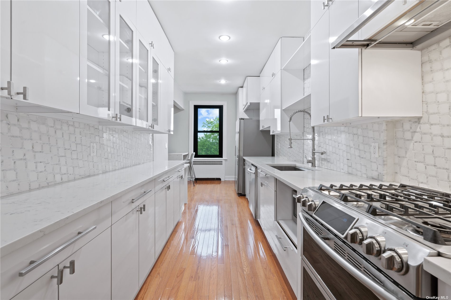 a kitchen with stainless steel appliances sink stove and cabinets
