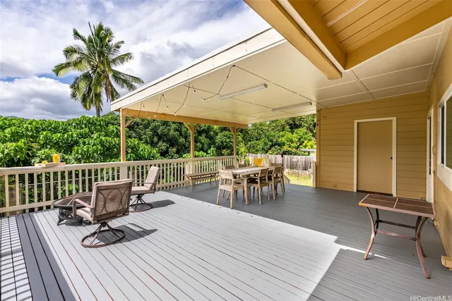a view of a chair and tables in the patio