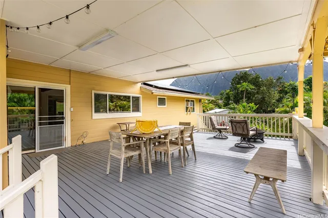 a view of balcony with wooden floor and outdoor seating