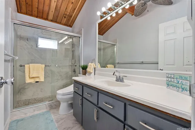 a bathroom with a sink a toilet and shower