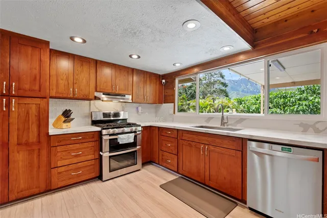 a kitchen with stainless steel appliances granite countertop a stove and a sink