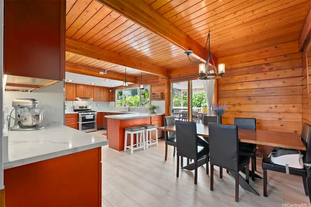 a dining area with chairs and table in the patio