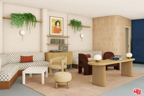 a living room with furniture a couch and a potted plant