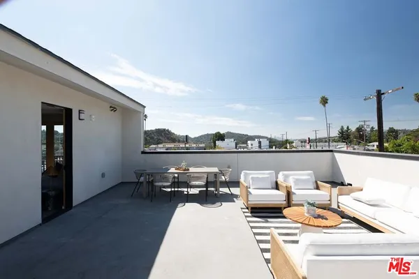 a terrace with outdoor seating and city view