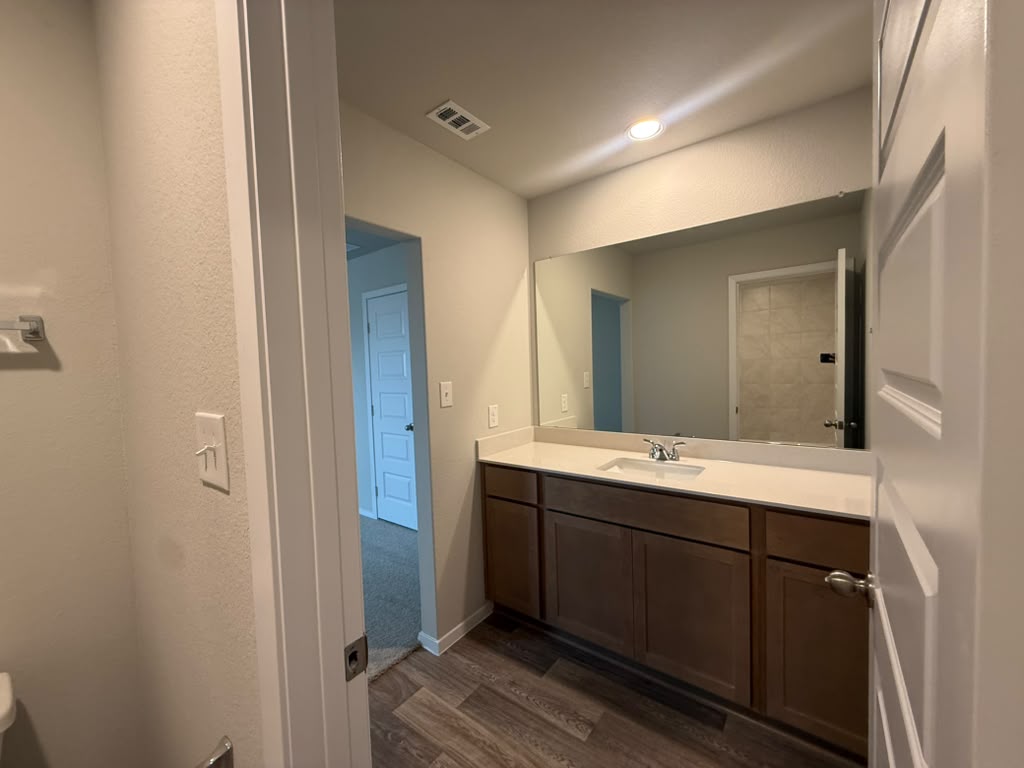 2601 Foss Road Manor, TX 78653 - Photo 33 of 40 A spacious vanity features stone counters and recessed lighting.