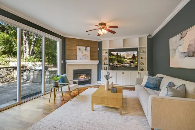 a living room with furniture a flat screen tv and a fireplace