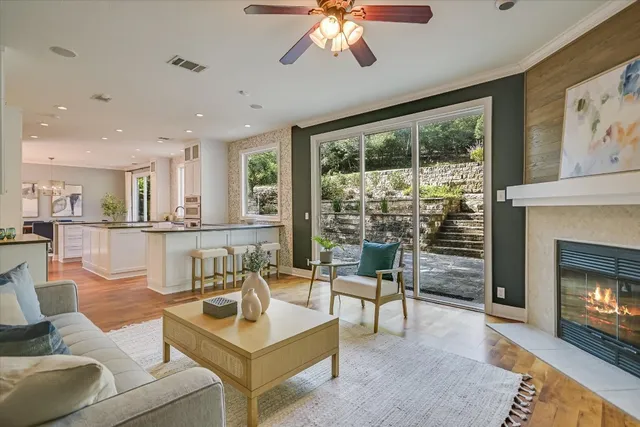 a living room with furniture a fireplace and a flat screen tv