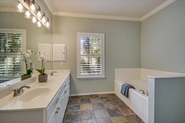 a bathroom with a sink a toilet a mirror and shower