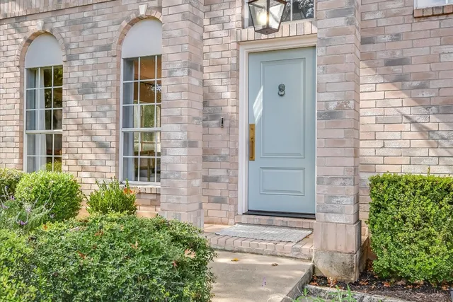 a couple of potted plants in front of a door