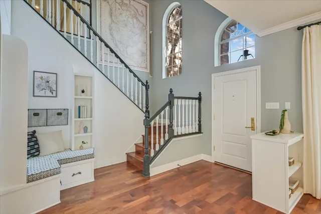 a view of a hallway with wooden floor and entryway