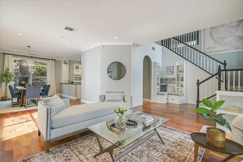 a living room with furniture potted plant and a table