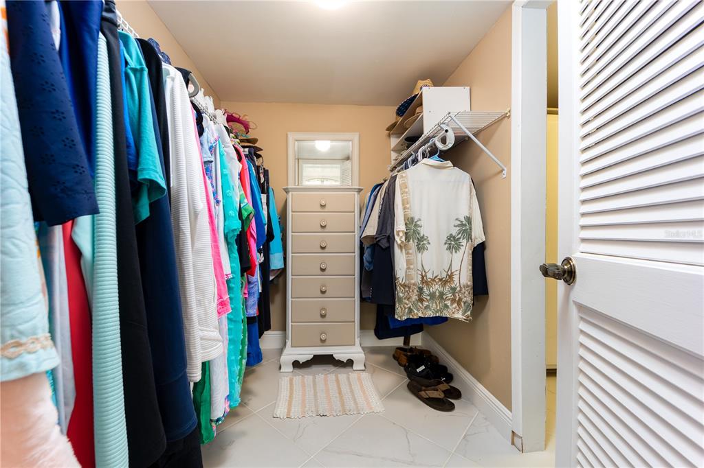 3100 Southeast Pruitt Road, Unit B102 Port St. Lucie, FL 34952 - Photo 17 of 33 a view of walk in closet with clothes and shoes