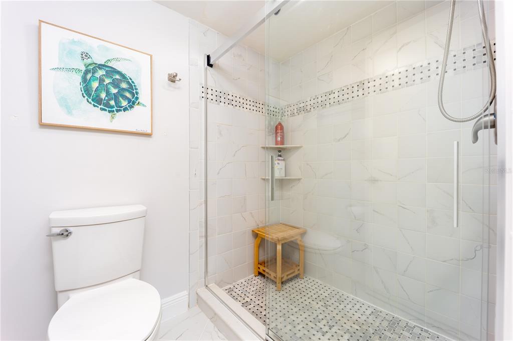 3100 Southeast Pruitt Road, Unit B102 Port St. Lucie, FL 34952 - Photo 22 of 33 a white toilet sitting next to a shower curtain