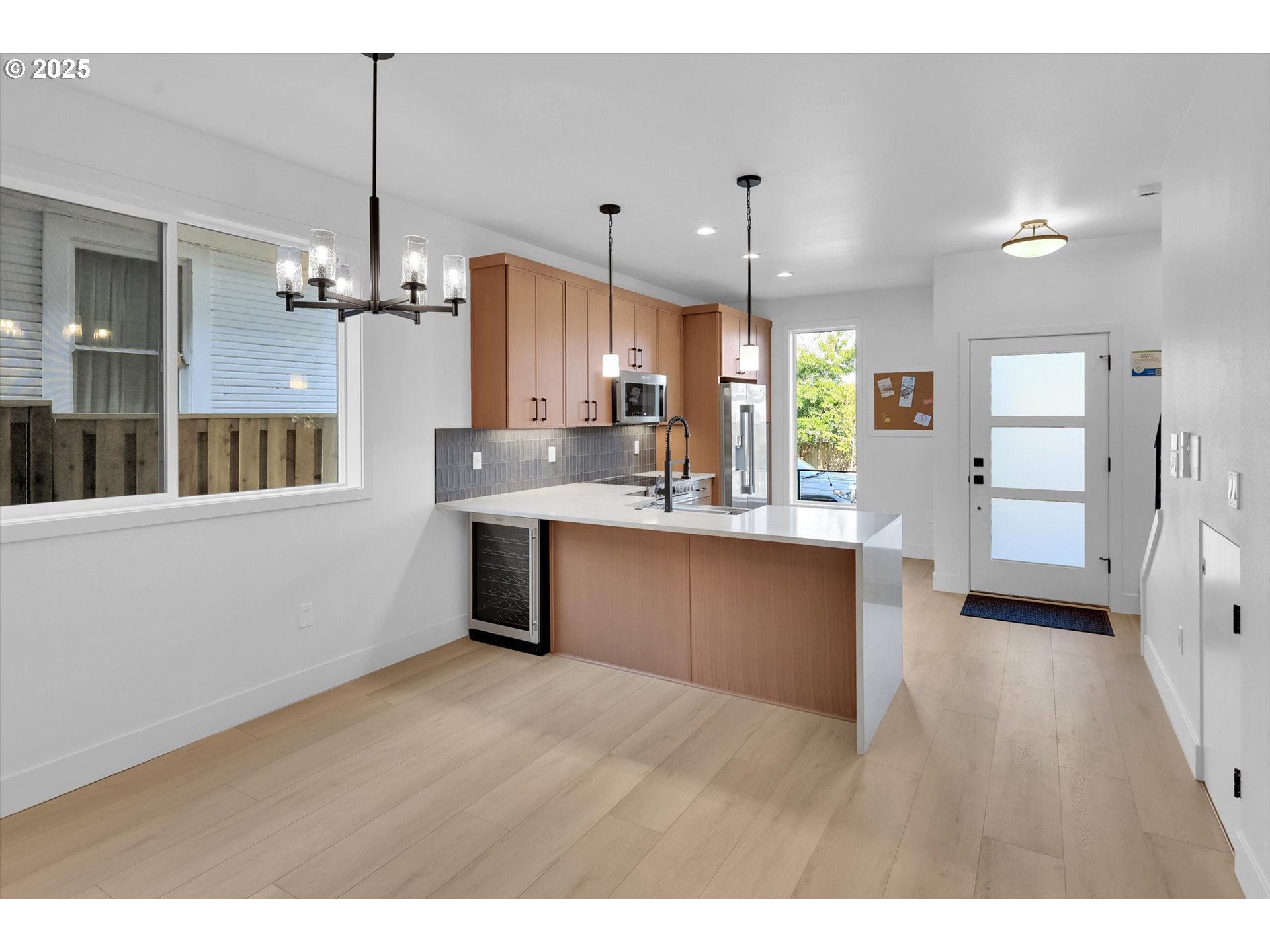 5773 South Kelly Avenue Portland, OR 97239 - Photo 14 of 33 a kitchen with stainless steel appliances kitchen island a refrigerator sink and cabinets