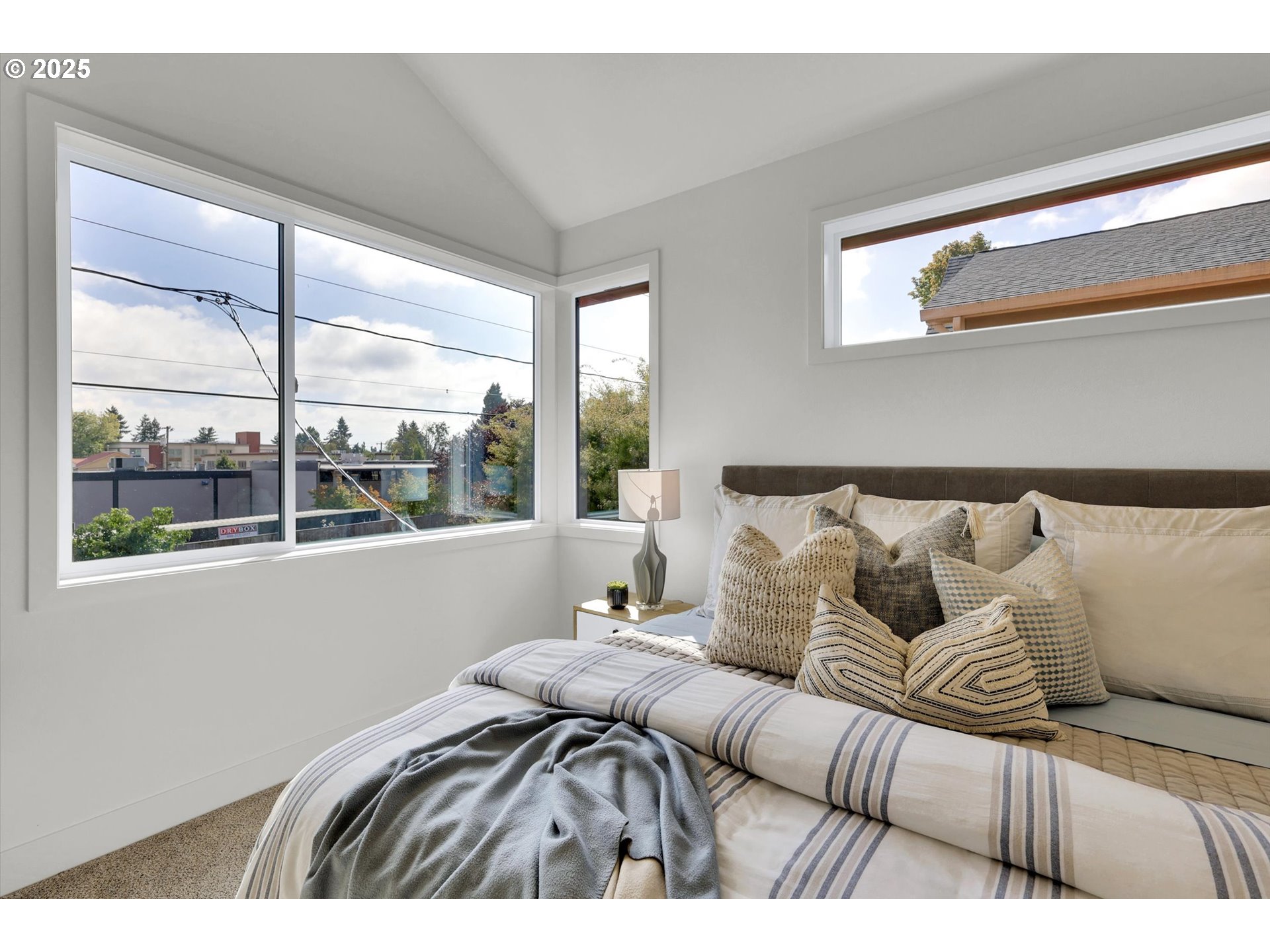 5773 South Kelly Avenue Portland, OR 97239 - Photo 21 of 33 a bedroom with a large bed and a large window