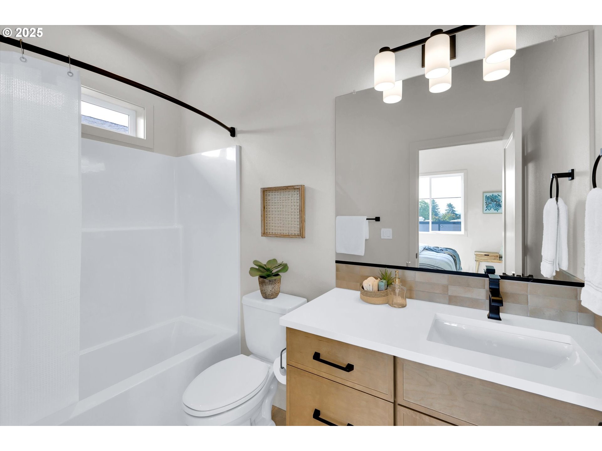 5773 South Kelly Avenue Portland, OR 97239 - Photo 25 of 33 a bathroom with a sink a toilet and a mirror