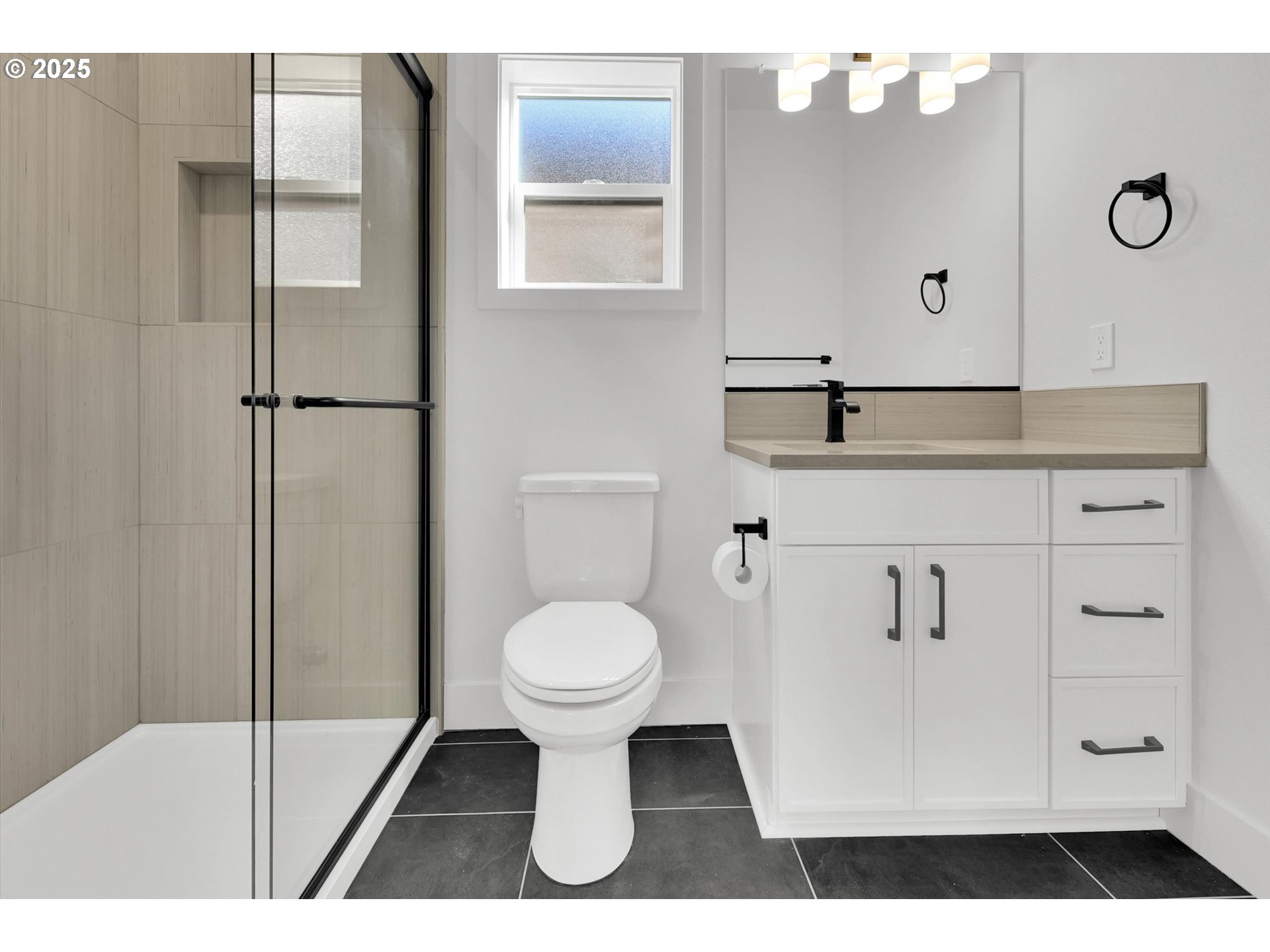 5773 South Kelly Avenue Portland, OR 97239 - Photo 30 of 33 a bathroom with a sink toilet a mirror and shower