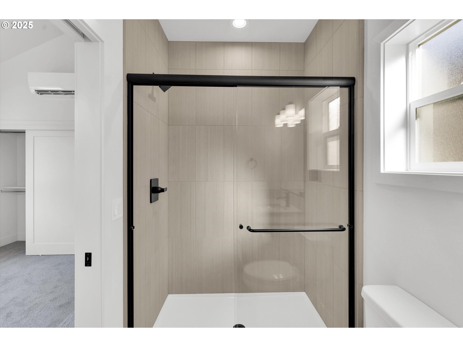 5773 South Kelly Avenue Portland, OR 97239 - Photo 31 of 33 a picture of a bathroom with a glass shower door