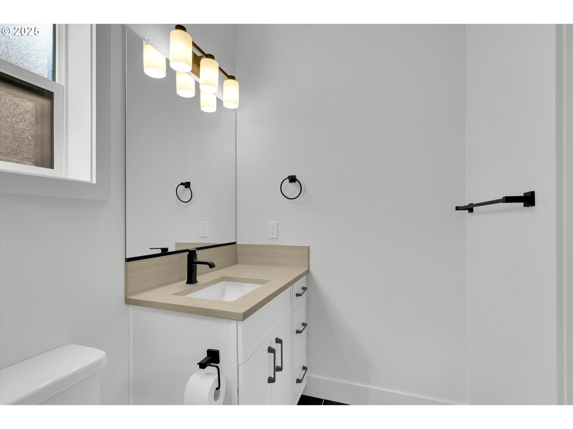5773 South Kelly Avenue Portland, OR 97239 - Photo 32 of 33 a bathroom with a sink a mirror and vanity