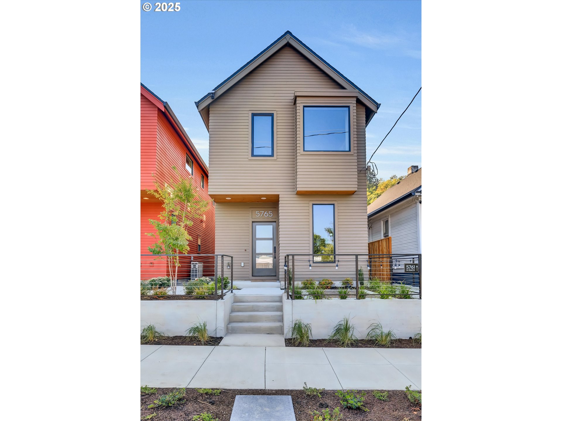 5773 South Kelly Avenue Portland, OR 97239 - Photo 4 of 33 a front view of a house with potted plants