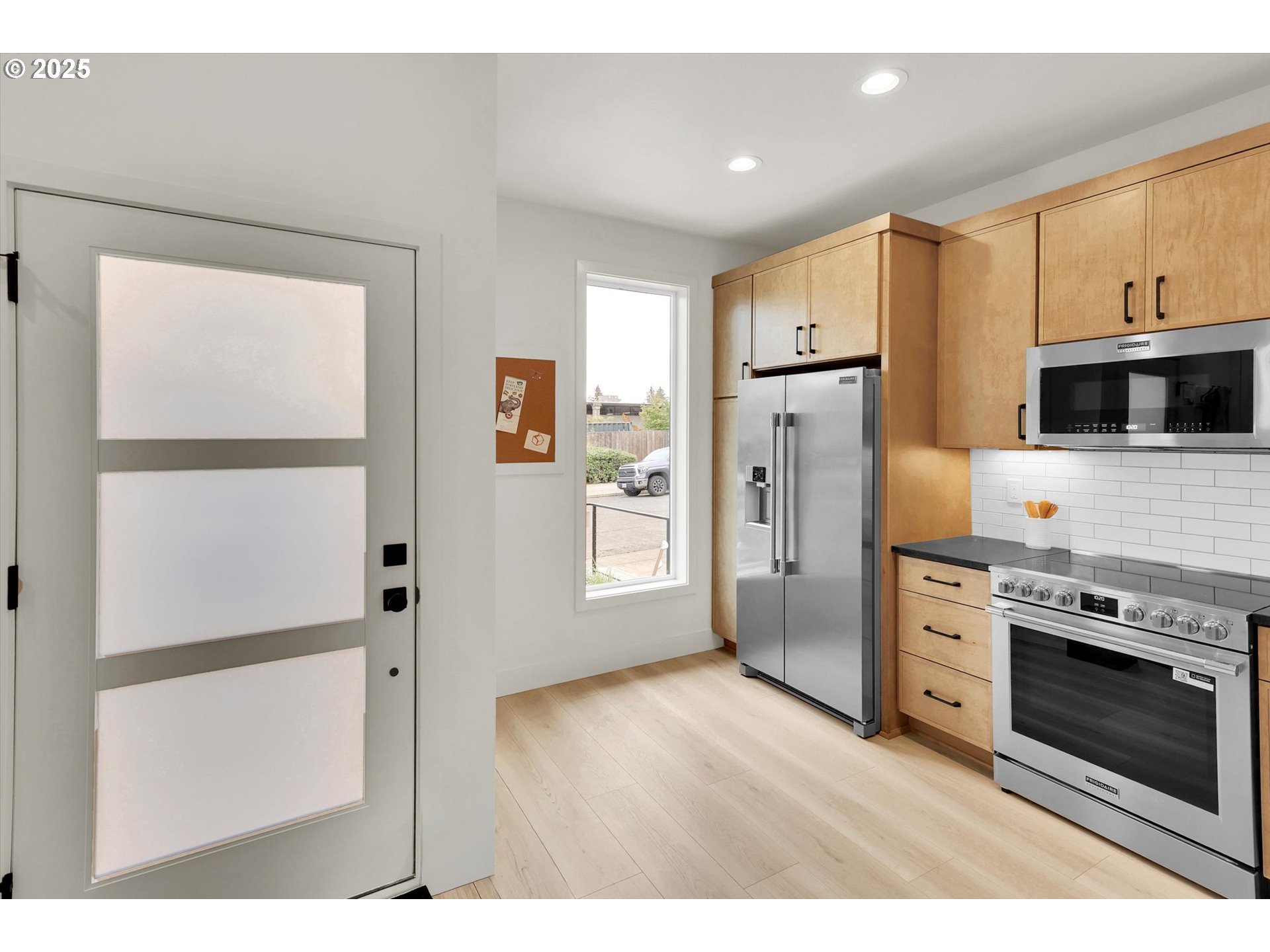 5773 South Kelly Avenue Portland, OR 97239 - Photo 7 of 33 a kitchen with stainless steel appliances a refrigerator sink and microwave