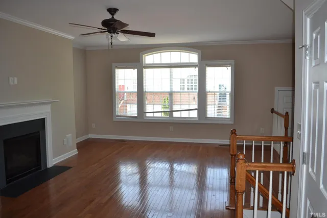 a view of a hallway with wooden floor and entryway