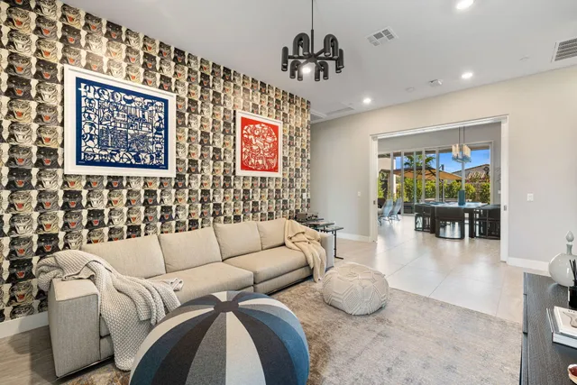 a living room with furniture and a chandelier