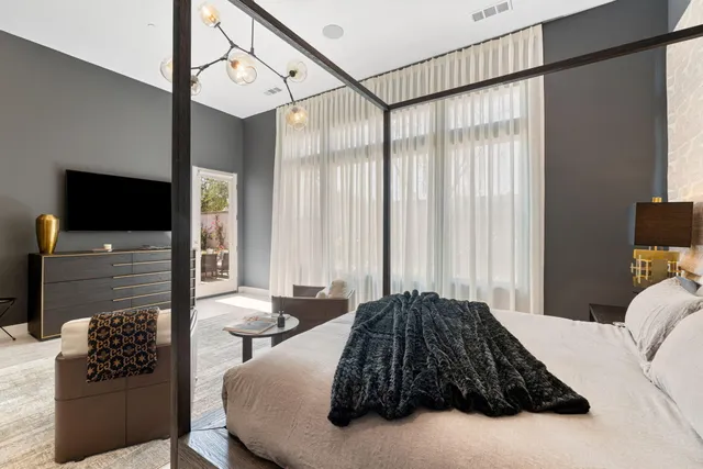 a spacious bedroom with a bed and a window