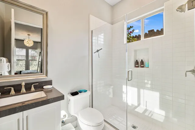 a living room with furniture a chandelier and a dining table