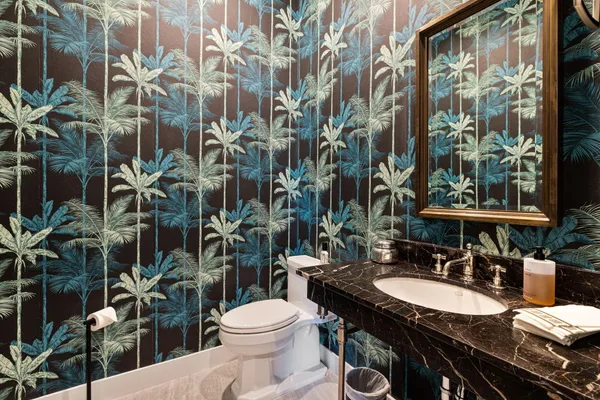 a kitchen with stainless steel appliances granite countertop a stove a refrigerator a kitchen island a sink and a stove