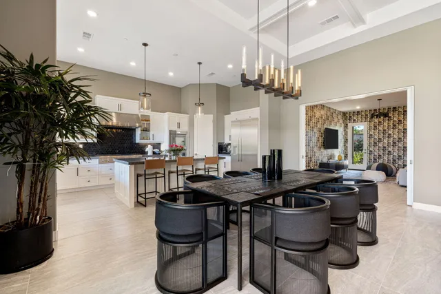 a kitchen with granite countertop a stove and a white cabinets
