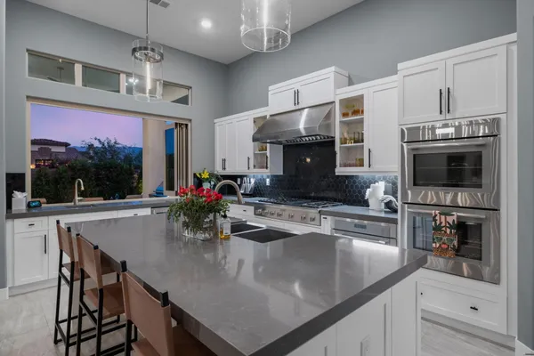 a view of a patio with a table and chairs and potted plants